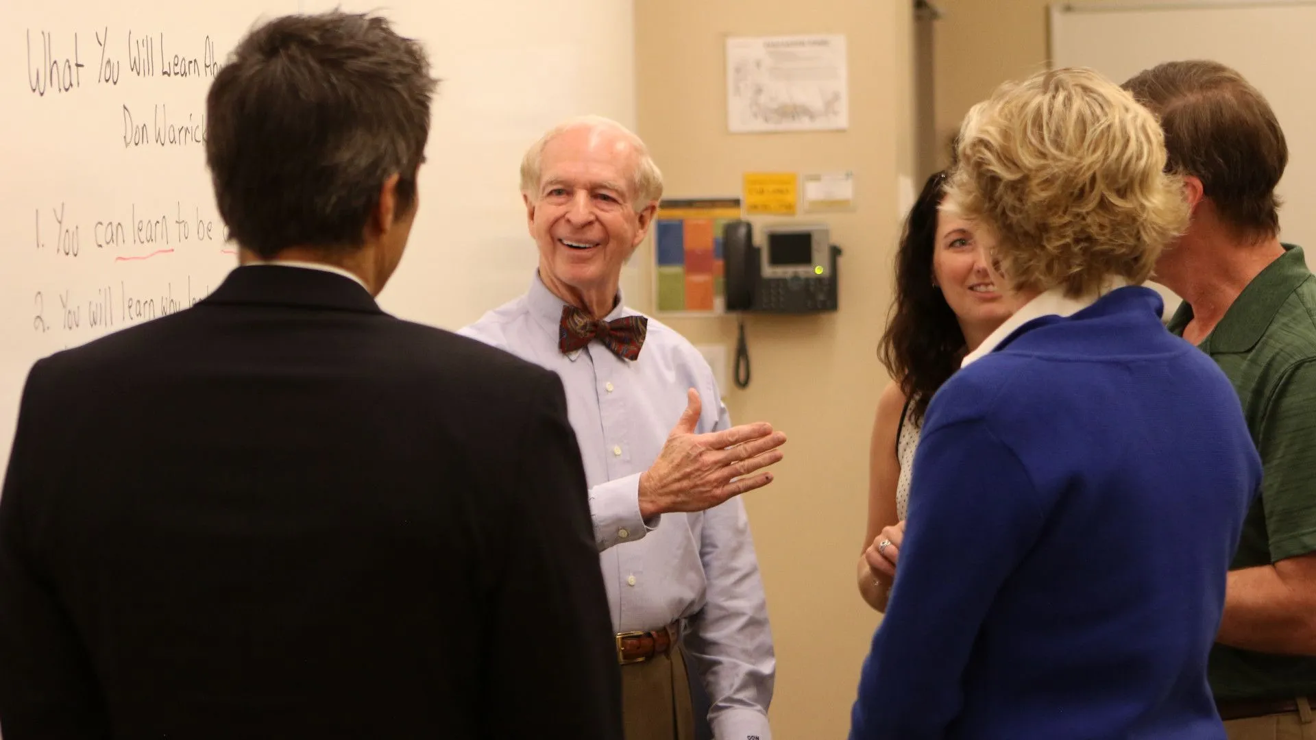 Faculty talking inside building